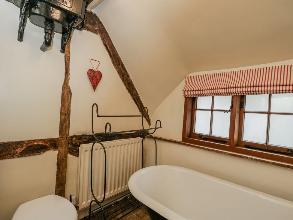 A bathroom with a bathtub and toilet at 24 Eastcourt