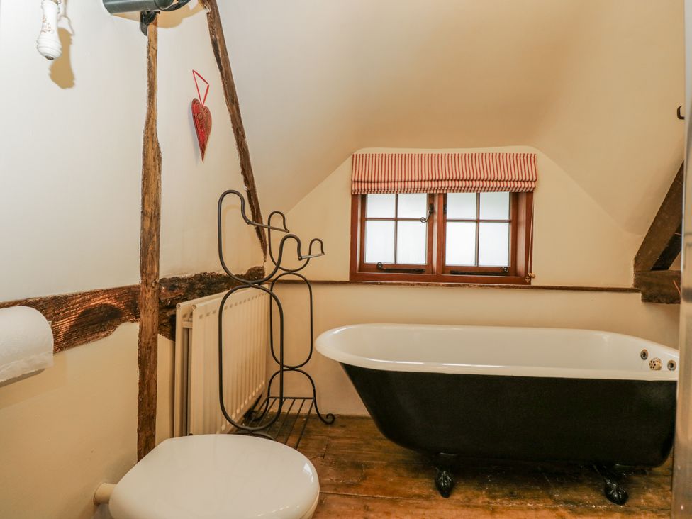 A bathroom with a bathtub and toilet at 24 Eastcourt