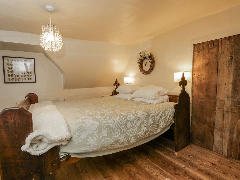 A bedroom with a bed and artwork at 24 Eastcourt in 