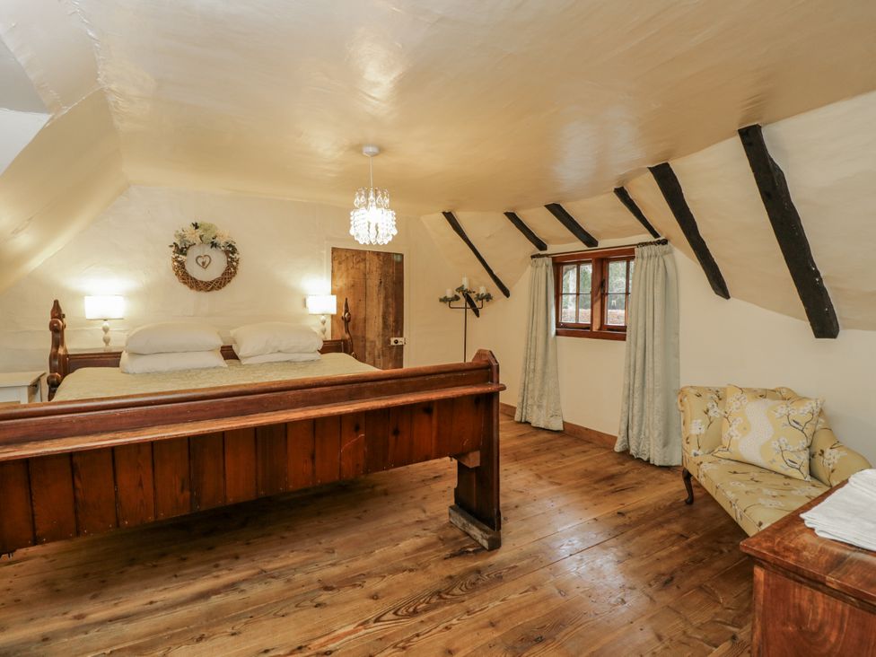 A bedroom with a bed and nightstand at 24 Eastcourt