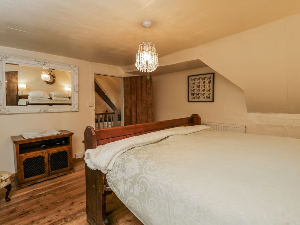 A bedroom with a bed and mirror at 24 Eastcourt
