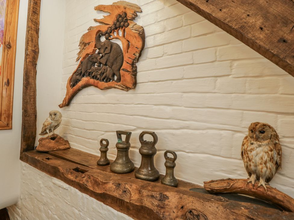 A wooden shelf with owls and weights at 24 Eastcourt