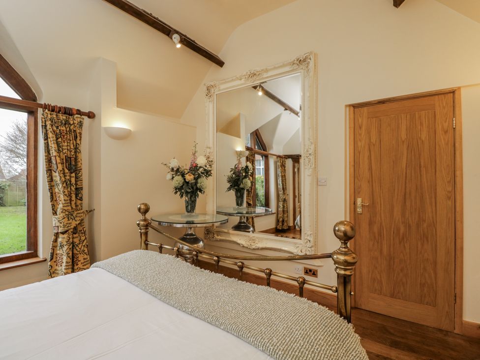 A bedroom with a bed and a mirror at 24 Eastcourt