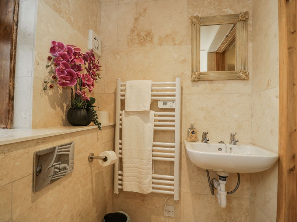A bathroom with a sink and towel rail at 24 Eastcourt