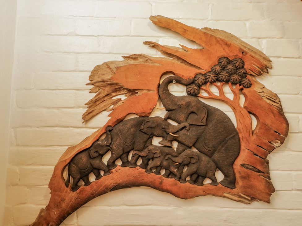 A wood carving of elephants and a tree