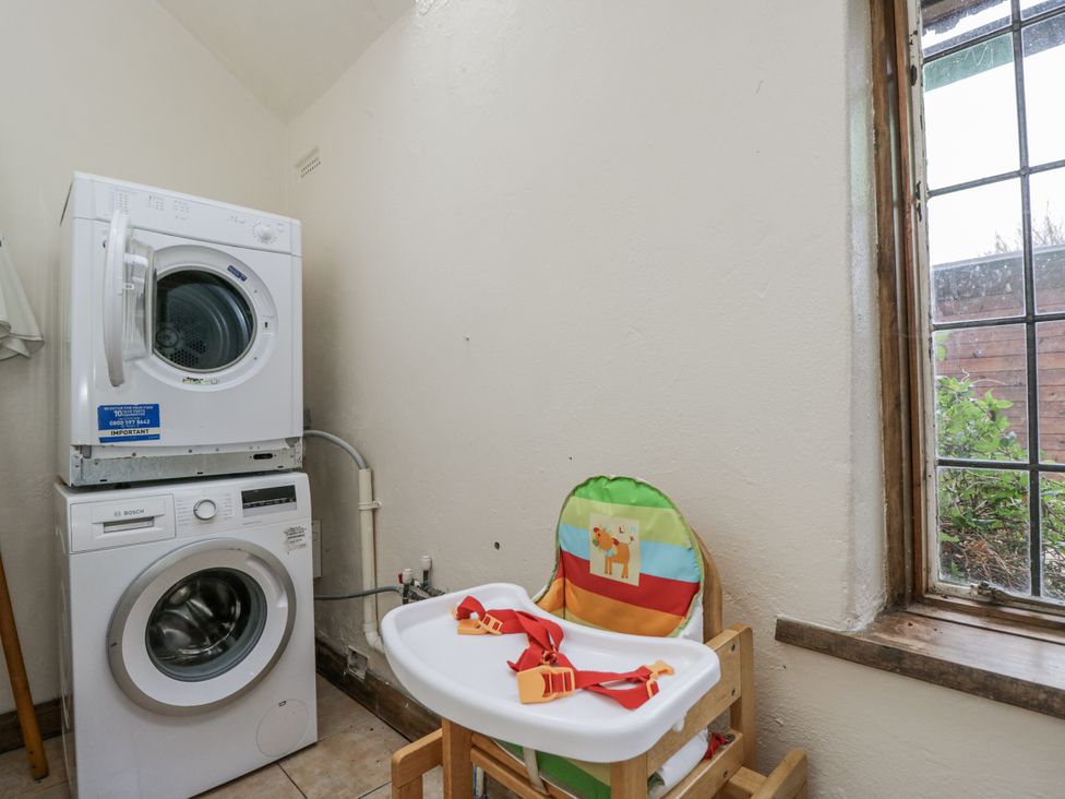 A laundry room with a washing machine and dryer at 24 Eastcourt