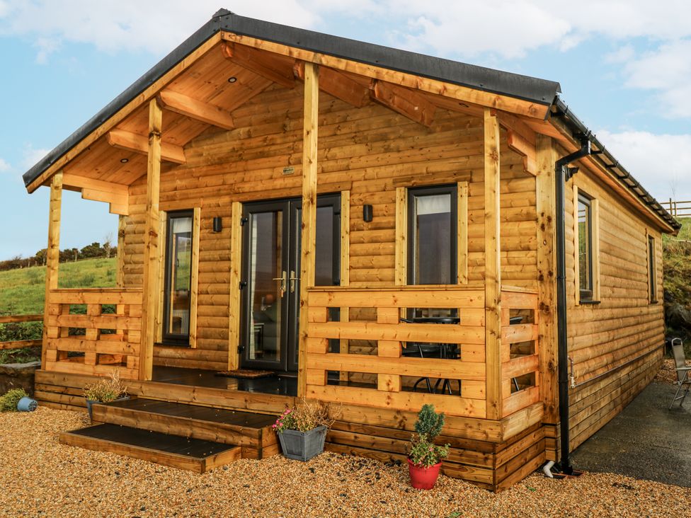 A log cabin with steps and porch at Glenview Log Cabin in Ballycastle