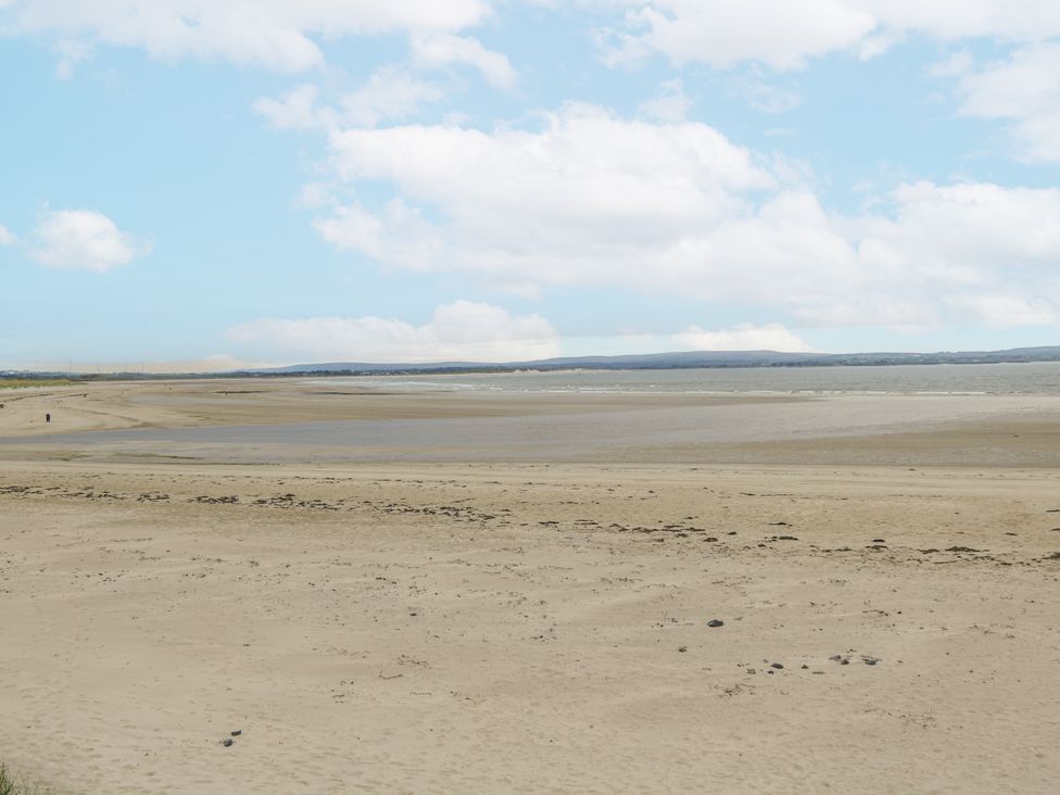 A beach with sand and water at Glenview Log Cabin in Ballycastle
