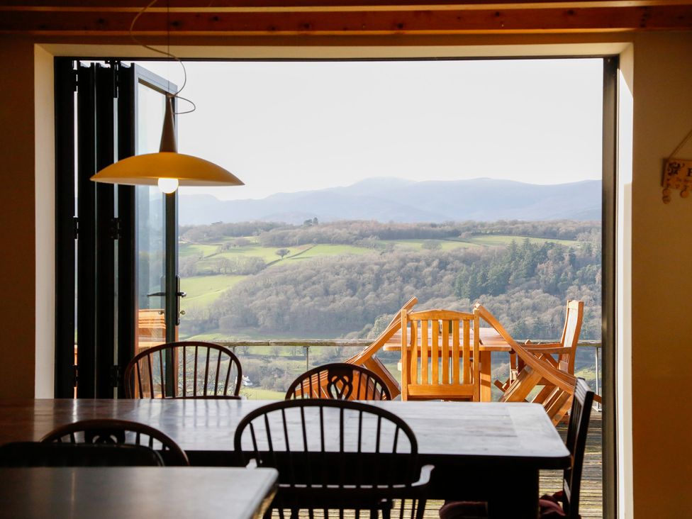 A dining room with a view of mountains at Ty Uchaf in Colwyn Bay