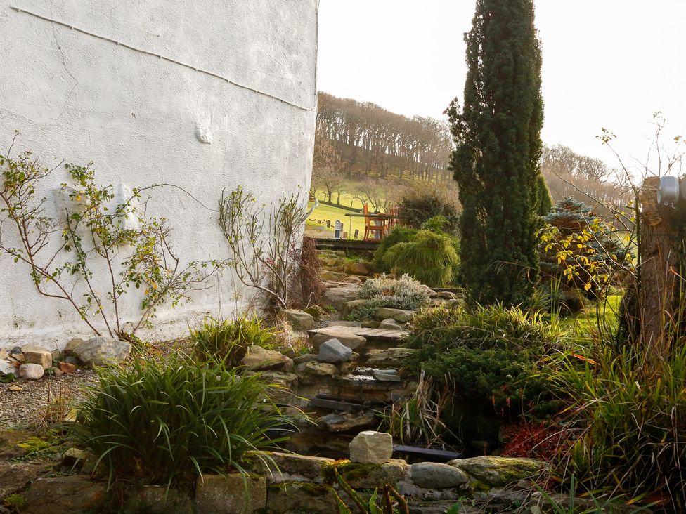 A garden with a stream and plants at Ty Uchaf in Colwyn Bay