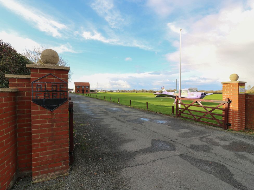 An entrance with a gate and an airplane at Aloe Farm in Diss