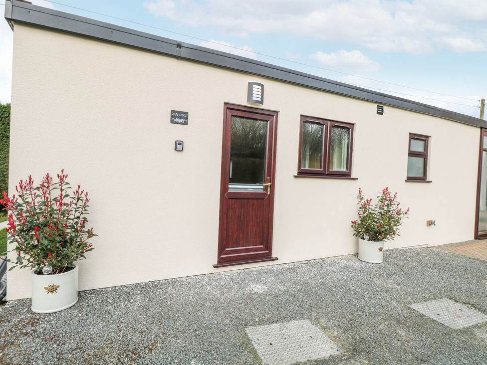 An exterior view of a building with windows and plants at Aloe Lodge in Banham