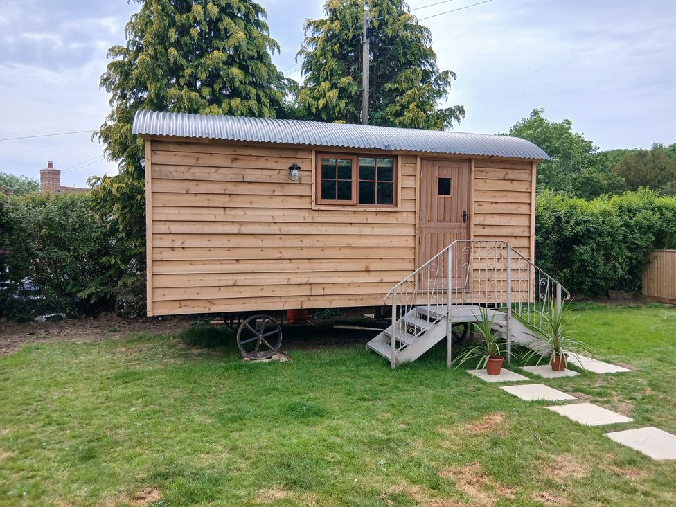 A wooden structure with steps in a garden at Woodie in Clee Hill