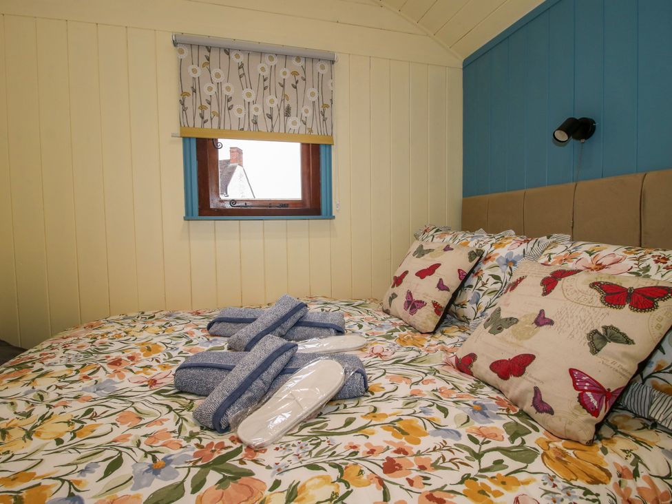 A bedroom with a bed and window at Woodie in Clee Hill