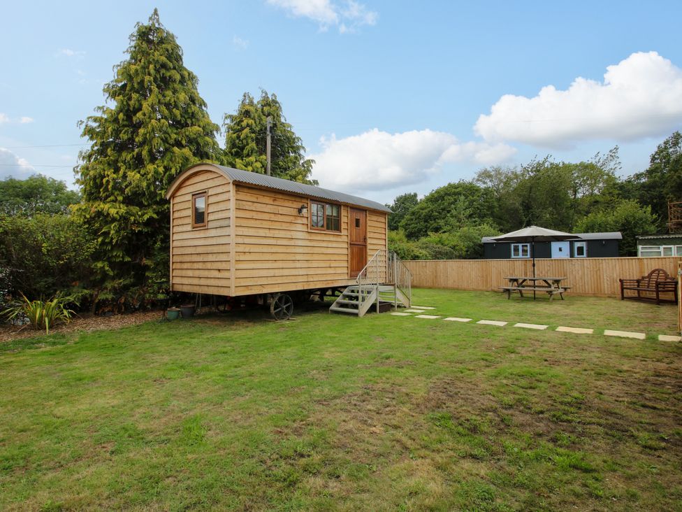 A wooden caravan in a garden at Woodie Clee Hill