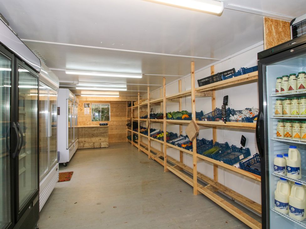 An indoor space with shelves and refrigerators at Woodie in Clee Hill