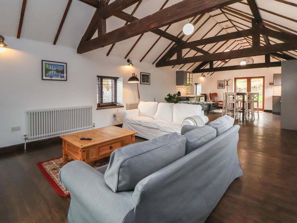 A living room with a sofa and coffee table at Quarry Barn in Wrexham