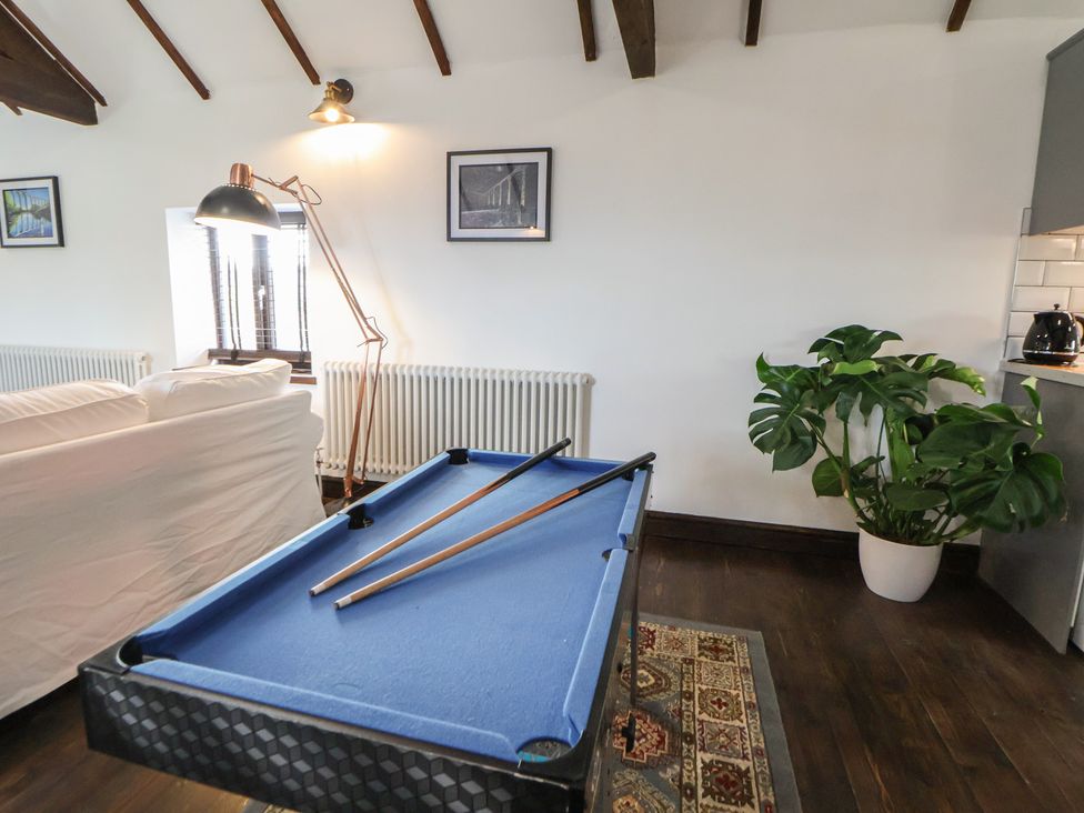 A snug with a pool table and a radiator at Quarry Barn in Wrexham