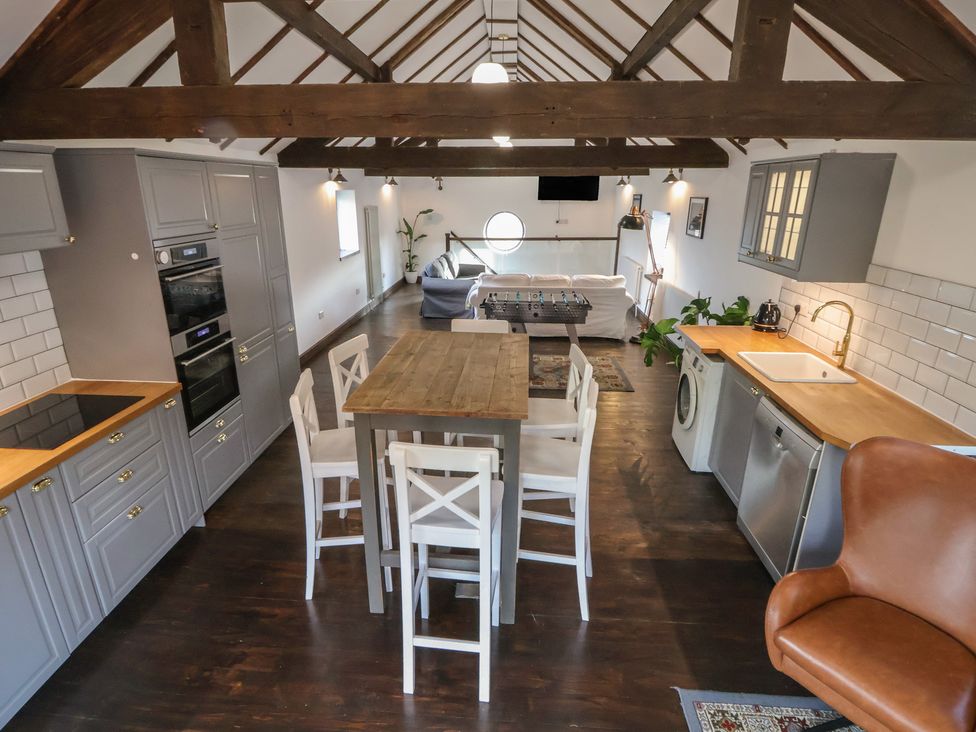 A kitchen with a table and chairs at Quarry Barn in Wrexham