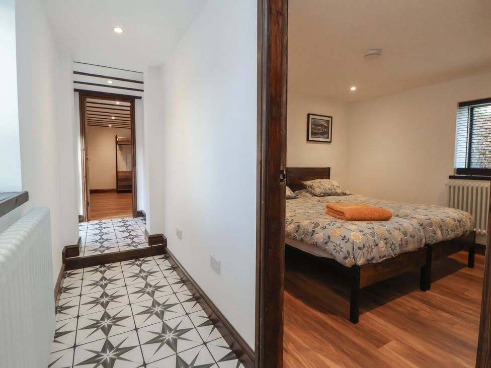 A bedroom with a bed and towel at Quarry Barn in Wrexham