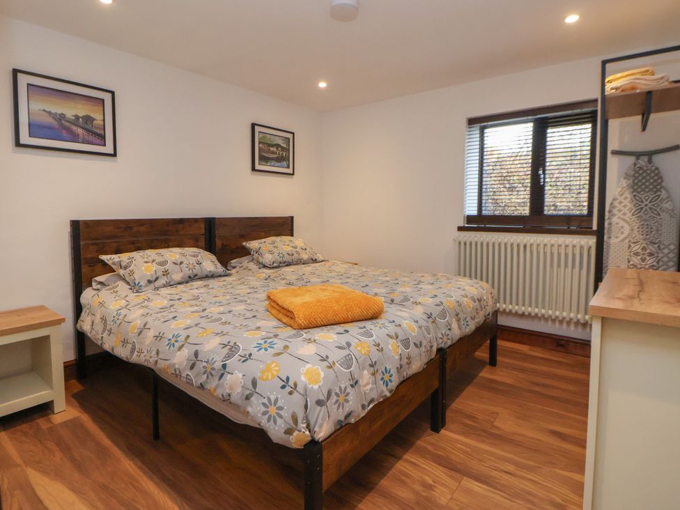 A bedroom with a bed and nightstand at Quarry Barn in Wrexham