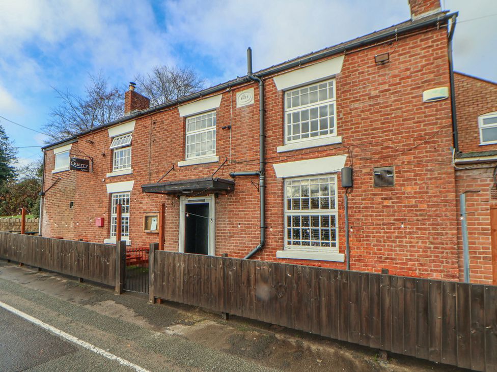 An exterior view of a building with a sign at Quarry Barn in Wrexham