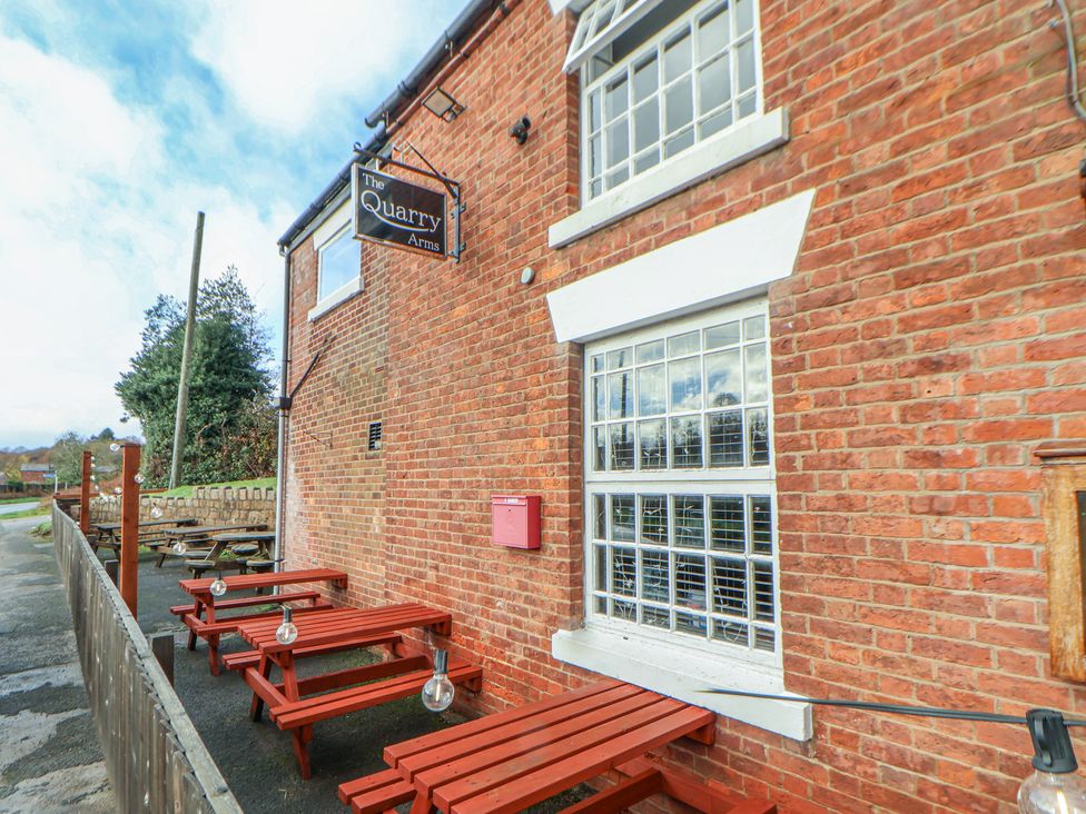 An outdoor view of The Quarry Arms with seating at Quarry Barn in Wrexham