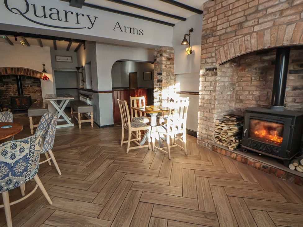 A dining room with table and chairs at Quarry Barn Wrexham