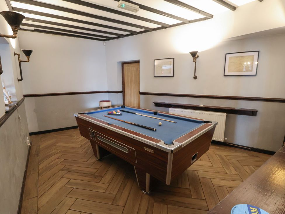A game room with a pool table at Quarry Barn in Wrexham