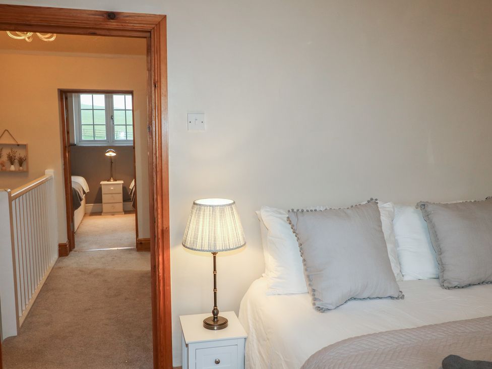 A bedroom with a bed and lamp at Little Launde Cottage Launde near Braunston-In-Rutland