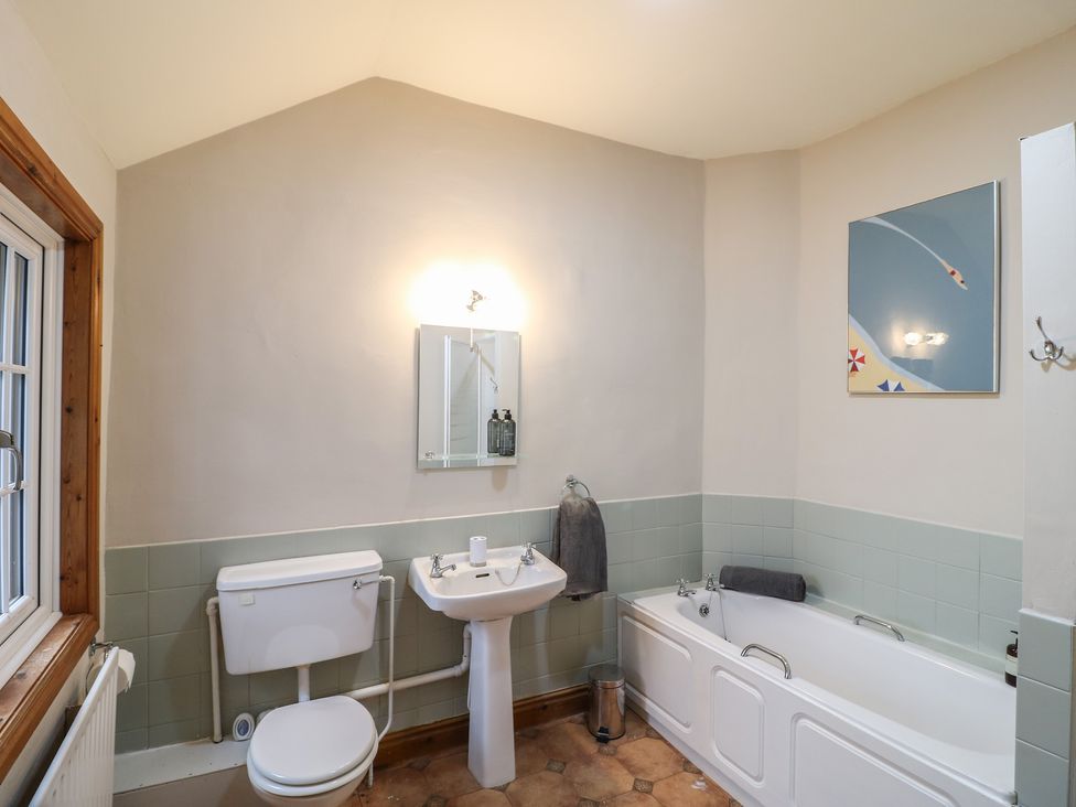 A bathroom with a sink and bathtub at Little Launde Cottage in Launde near Braunston-In-Rutland