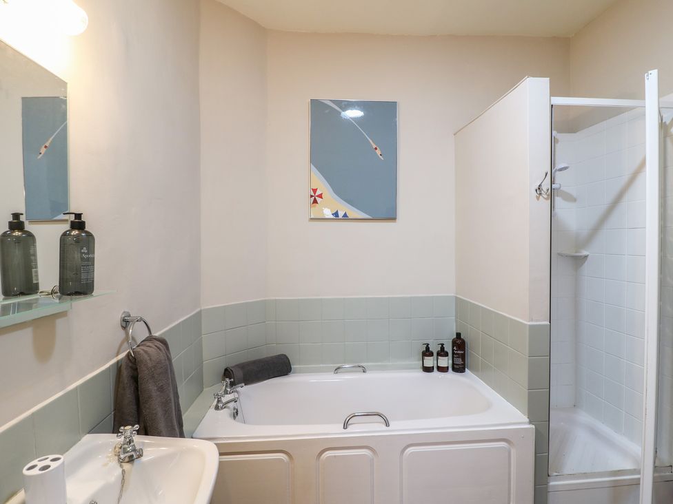A bathroom with a bathtub and a shower at Little Launde Cottage in Launde near Braunston-In-Rutland