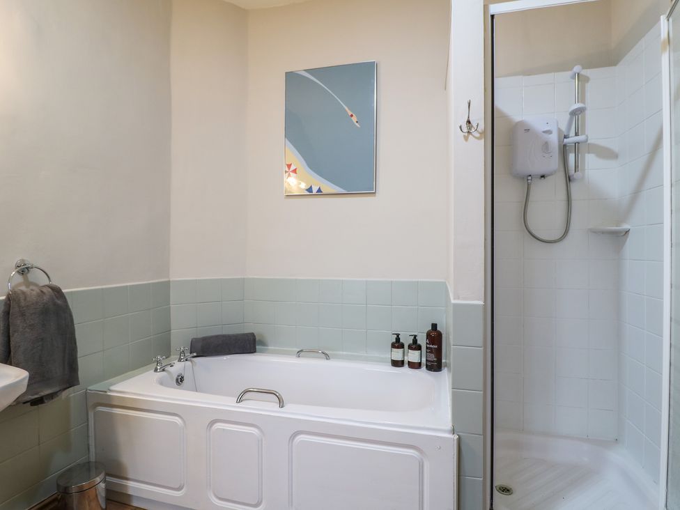 A bathroom with a bathtub and shower at Little Launde Cottage Launde near Braunston-In-Rutland