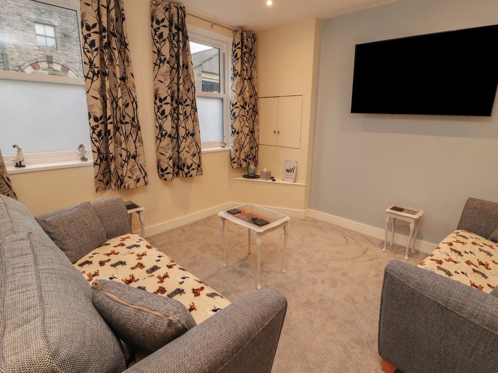 A living room with a sofa and television at 20 Lorton Street Cockermouth