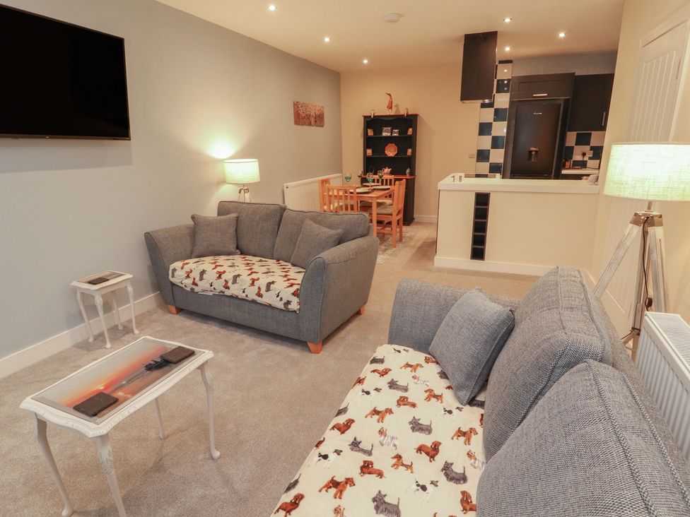 A living room with a sofa and television at 20 Lorton Street Cockermouth