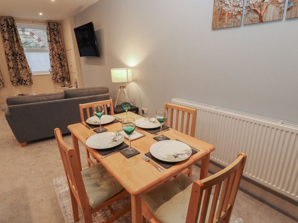 A dining room with a table and chairs at 20 Lorton Street Cockermouth