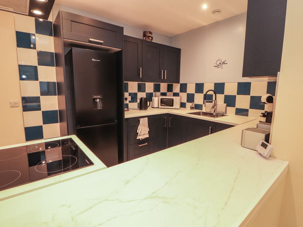 A kitchen with appliances and cabinets at 20 Lorton Street in Cockermouth