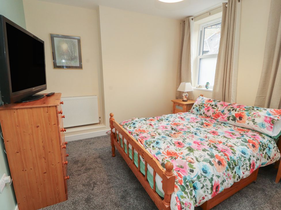 A bedroom with a bed and television at 20 Lorton Street Cockermouth