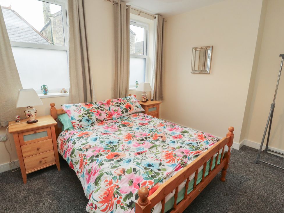 A bedroom with a bed and bedside tables at 20 Lorton Street Cockermouth