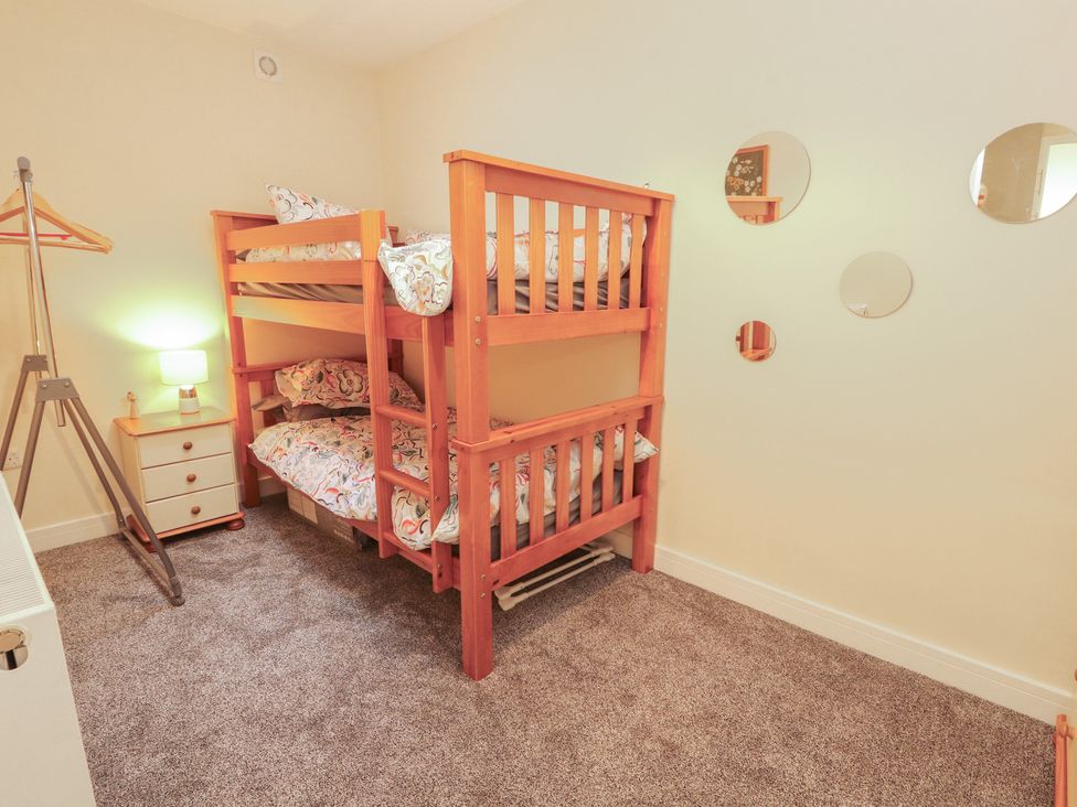 A bedroom with a bunk bed and a lamp at 20 Lorton Street in Cockermouth