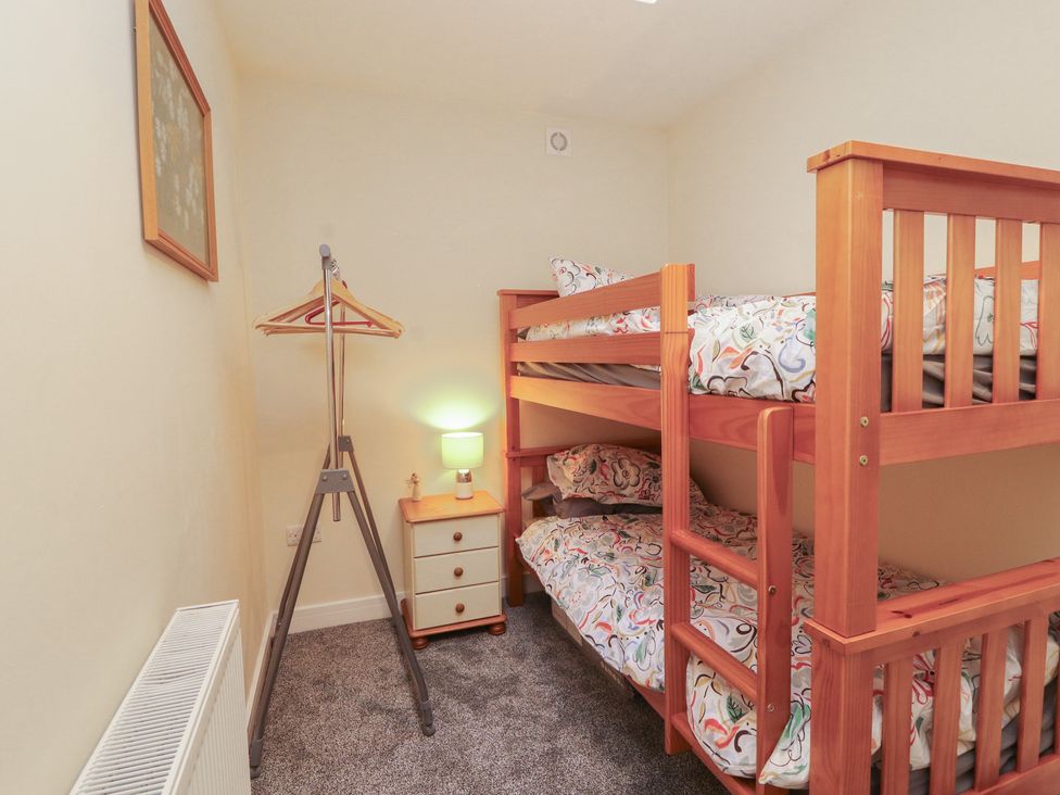 A bedroom with a bunk bed and a lamp at 20 Lorton Street Cockermouth