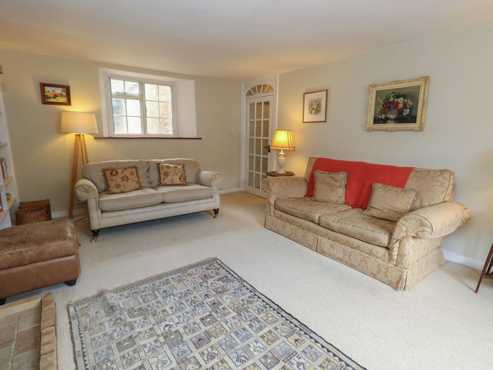 A living room with a sofa and armchair at Crantock