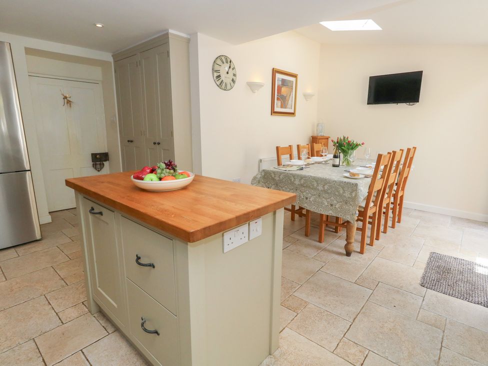 A kitchen with an island and dining area at Crantock