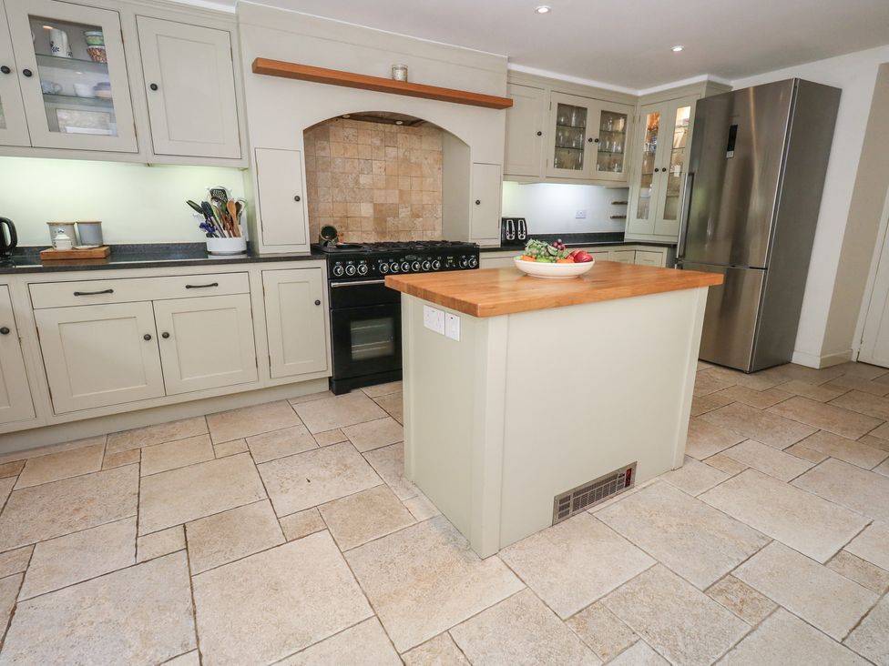 A kitchen with cabinets and a stove at Crantock in 