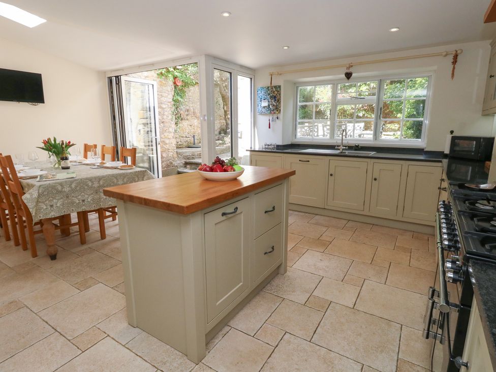 A kitchen with a dining area and appliances at Crantock