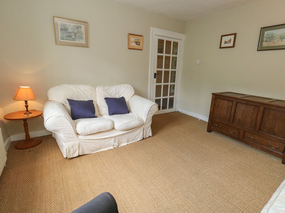 A living room with a sofa and side table at Crantock