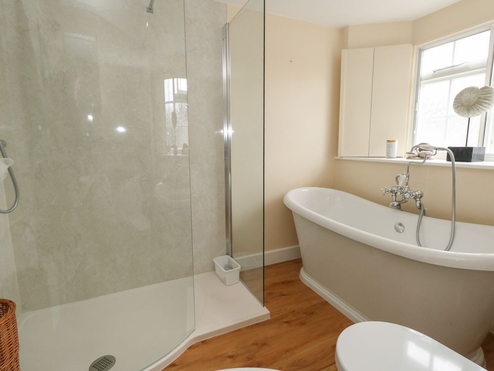 A bathroom with a shower and bathtub at Crantock