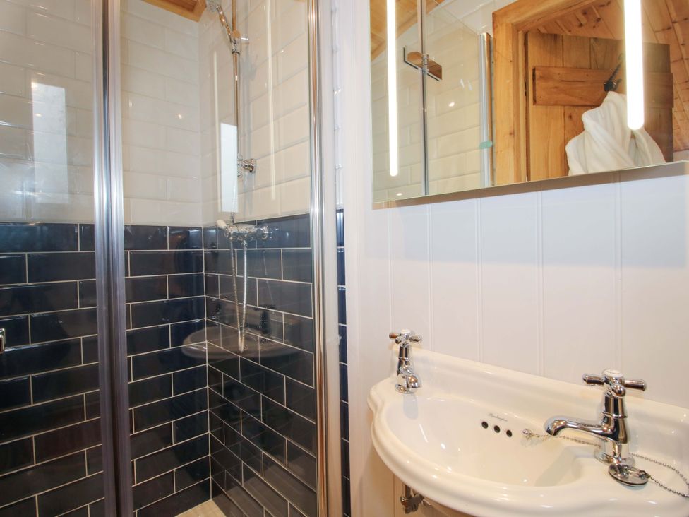 A bathroom with a shower and sink at Dave’s Place Broadstone near Munslow