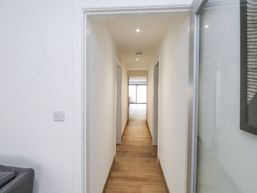 A hallway with doors on either side at Bigting in Rhosneigr