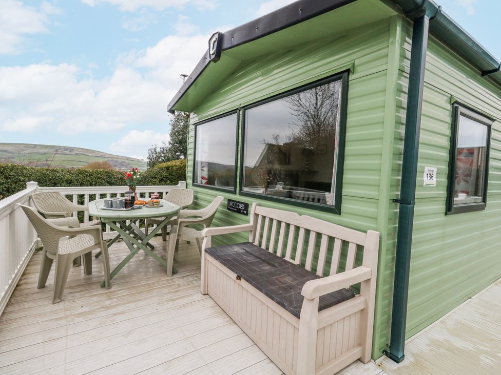 An outdoor area with a table and chairs at Swanage Coastal Park Caravan in Swanage